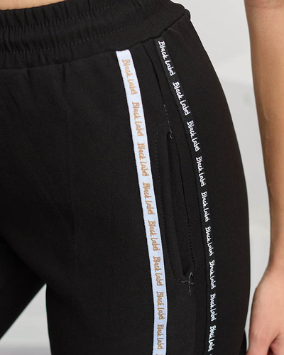 Női fekete cargo nadrág csíkokkal - Ruházat