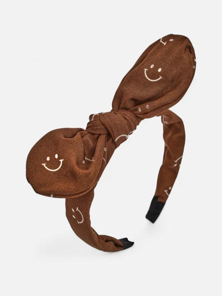 Royalfashion Gyermek hajpánt mosolygós arcokkal díszített masnival